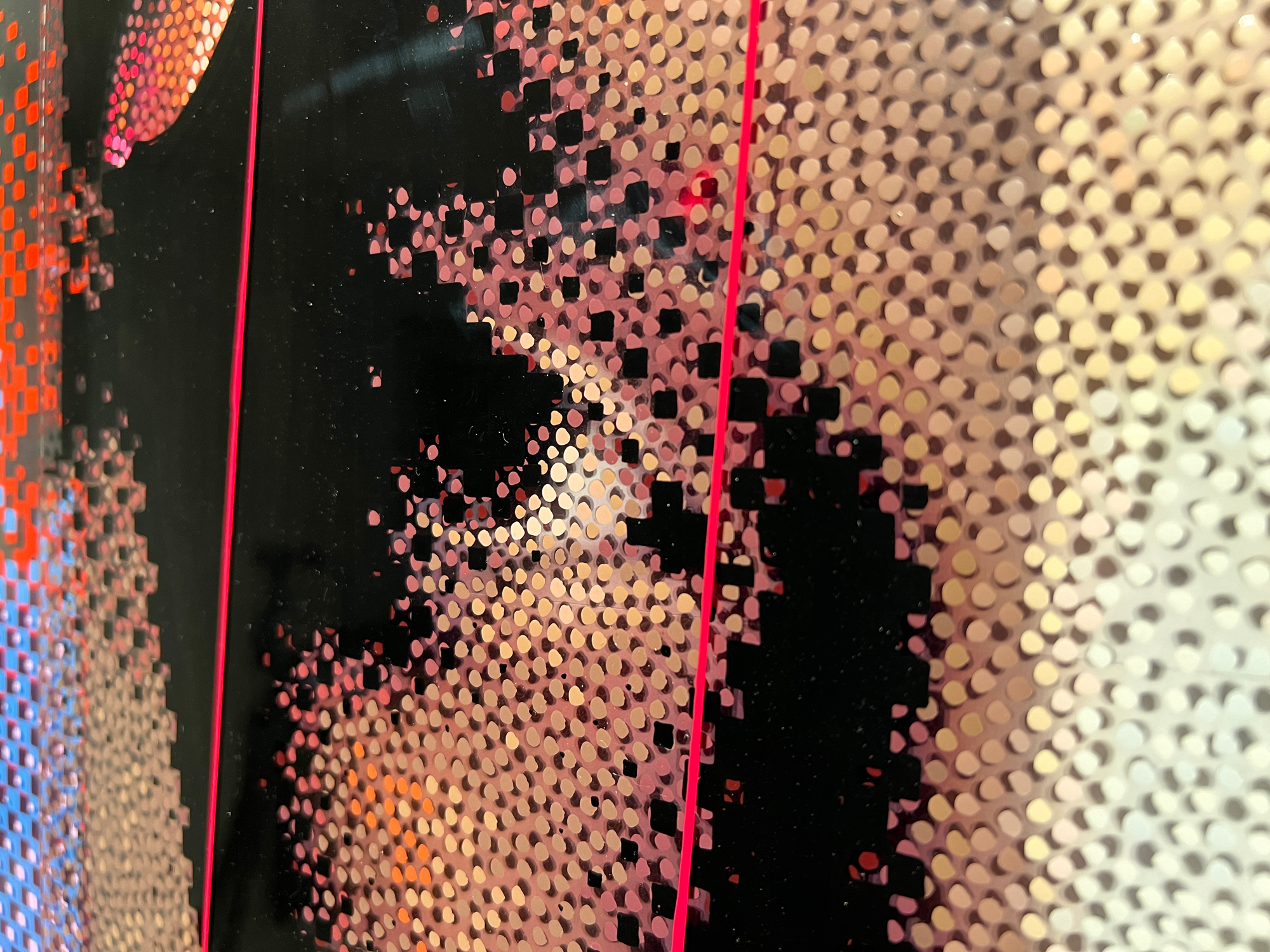 One Race – Close-up of layered portrait details and pink plexiglass edges