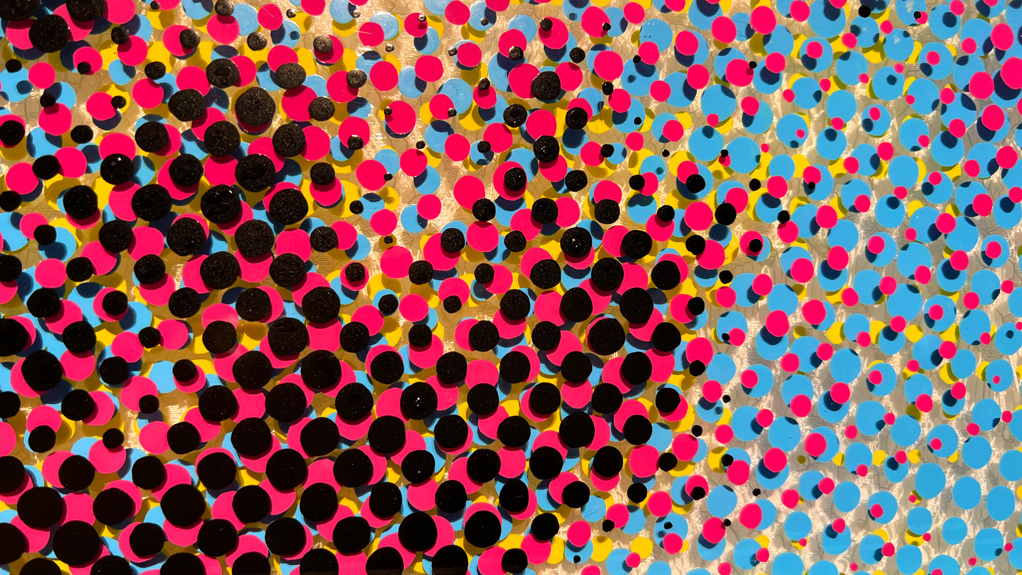 Wholey Mas – Detail of pink, blue, yellow, and black dots on textured lace layer