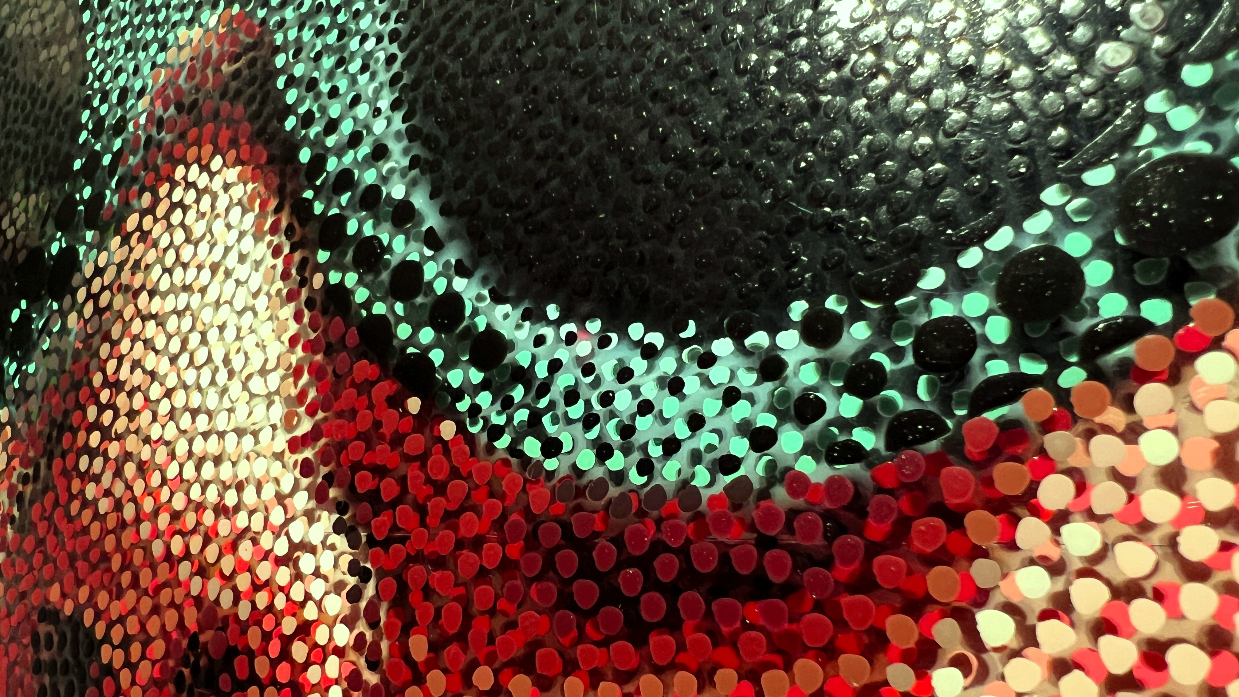 Yayoi Kusama – Close-up of black, teal, and red Neo-Pointillist dots on plexiglass